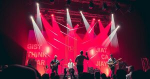 A vibrant stage set at night with bright lights and musical instruments for a concert performance.