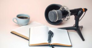 A calm workspace with a microphone, coffee cup, and notebook, reflecting a pause in podcasting activities.